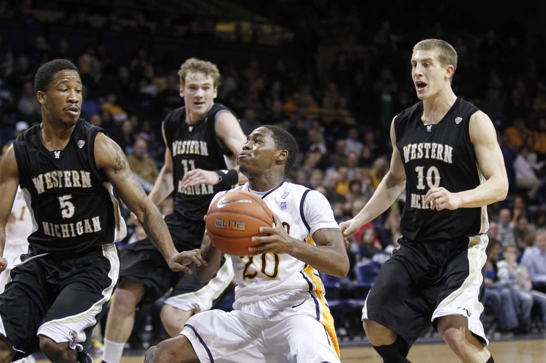University-of-Toledo-player-Julius-Brown-20-drives-against-the-Western-Michigan-defense-of-Mike-Douglas-5-Nate-Hutcheson-11-and-Brandon-Pokley-10