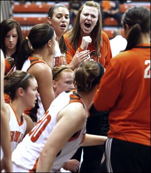 Bowling Green senior Maribeth Giese, back, center, cheers on her Falcons teammates during a game this season. Giese had heart surgery in November, forcing her to end her career prematurely. The team will honor her and Jessica Slagle on Saturday.