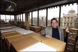 CTY image24p Clerk of Court Bernie Quilter with boxes of papers to be scanned, says counties need to help each other.