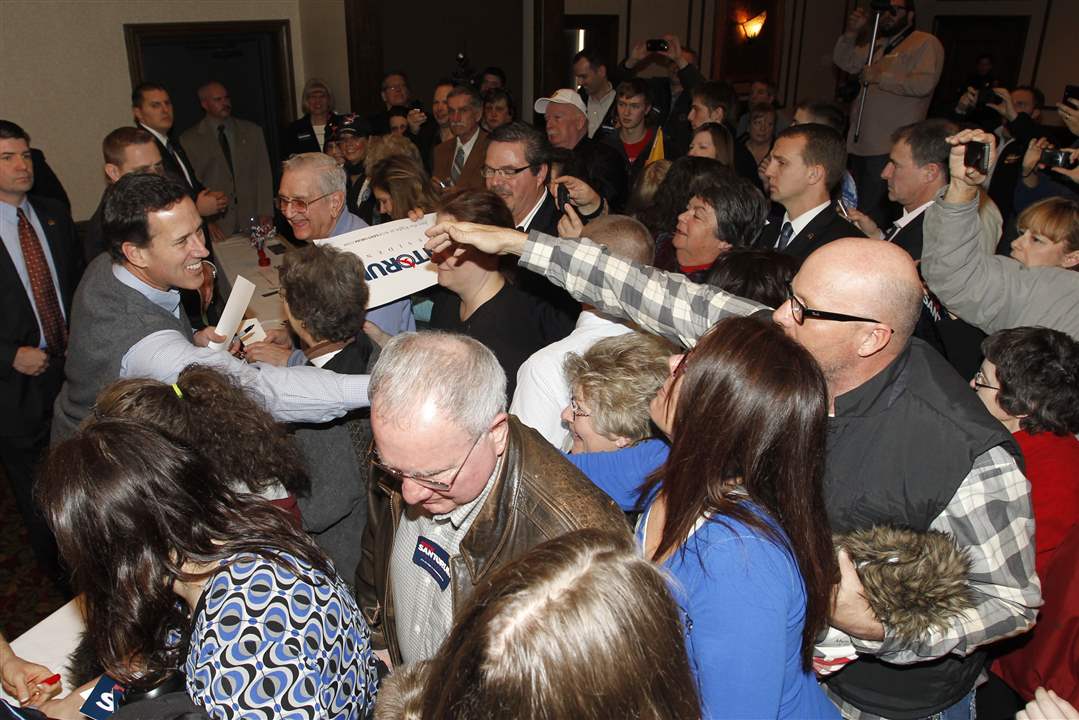 Republican-presidential-candidate-Rick-Santorum-shakes-hands-during-a-rally
