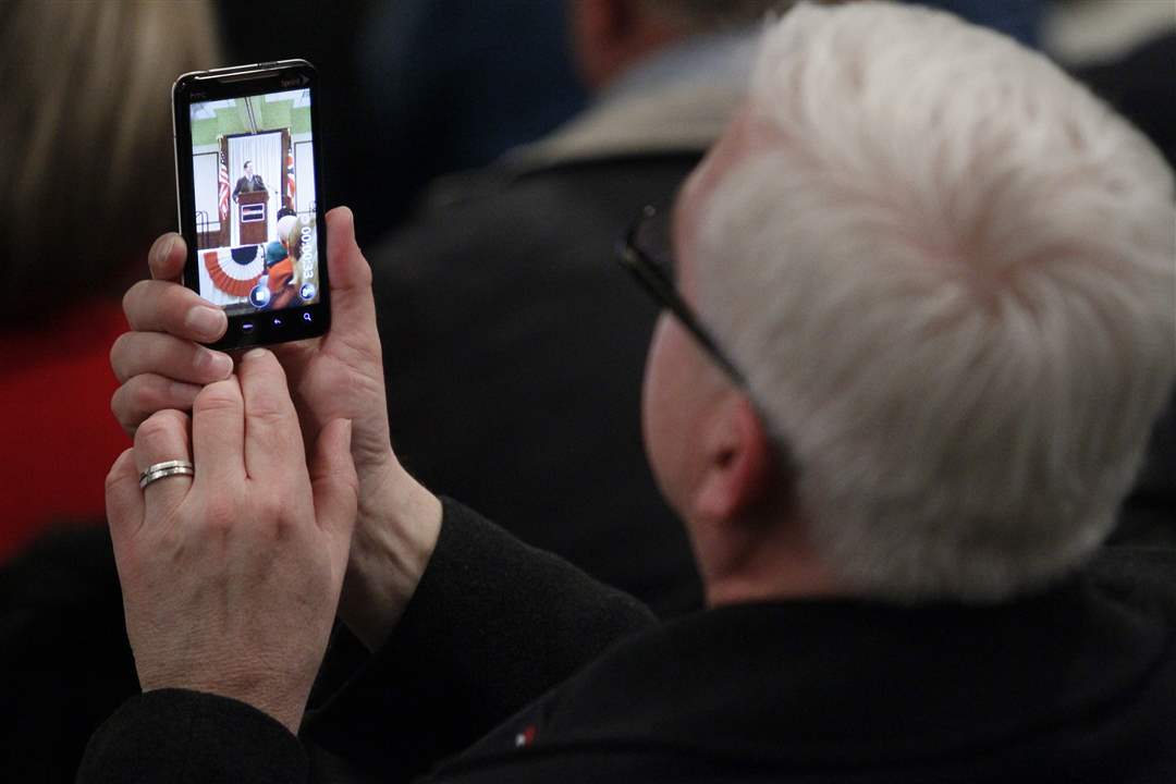 Steve-Kraus-a-candidate-in-the-9th-district-takes-a-photo-of-Republican-presidential-candidate-Rick-Santorum