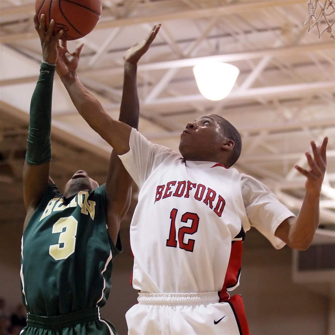 Bedford-s-Kenneth-McFadden-12-tries-to-shoot-over-Ann-Arbor-Huron-s-Khari-Hutchings
