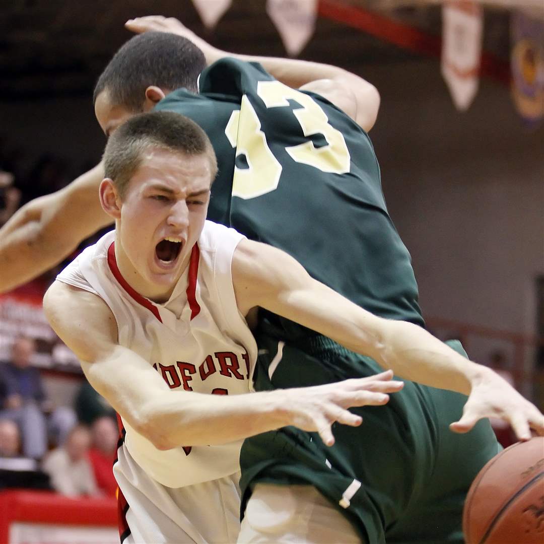 Bedford-s-Ryan-Rightnowar-24-collides-with-Ann-Arbor-Huron-s-Mike-Lewis