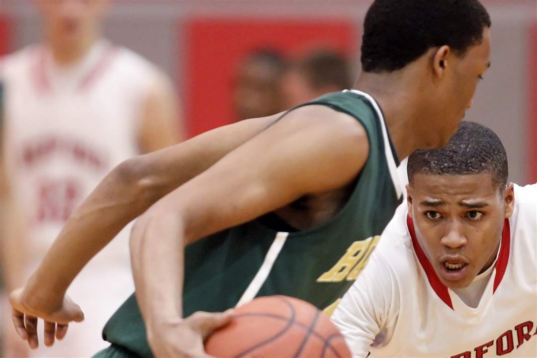 Bedford-s-Kenneth-McFadden-12-defends-against-Ann-Arbor-Huron-s-Antonio-Henry