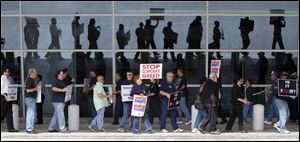 Protestors march outside the terminal during a protest against proposed job cuts by AMR at Dallas-Fort Worth International Airport.