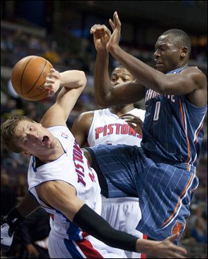 Charlotte Bobcats' Bismack Biyombo (0) loses the ball after colliding with Detroit Pistons' Jonas Jerebko, leftn, in the first half Wednesday night.