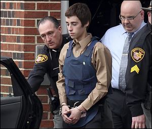 Sheriff's deputies escort shooting suspect Thomas ‘T.J.' Lane out of the Geauga County Courthouse. 