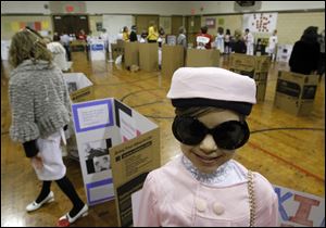 A pillbox hat and big sunglasses help transform Kennedy Kersten into Jacqueline Kennedy Onassis.
