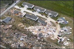 Homes in the southern Illinois city of Harrisburg are heavily damaged by the storm that killed six people there.