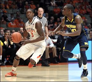 Illinois guard Brandon Paul (3) drives past Michigan guard Tim Hardaway Jr. (10) in the first half Thursday night's game.
