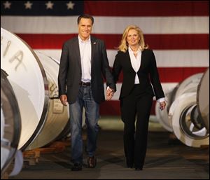 Mitt Romney and wife, Ann, walk between metal coils at Universal Metals LLC in North Toledo on Wednesday.