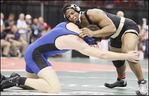 Perrysburg's Micah Carter, right, grapples with Marysville's Tomas Taylor. The senior was one of three Yellow Jackets to advance in the championship bracket with a 5-3 win.