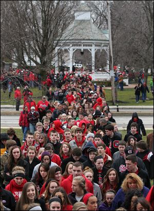 Chardon High School students, along with parents and supporters, march from the town square to the school. The 'walk-through' let students re-enter the buildings for the first time since the shootings. Regular classes are scheduled for all grades Friday. 