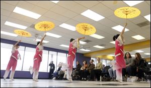 Members of the Toledo Academy of Tai Chi and Martial Arts, above, put on a display of Chinese folk dancing Saturday during  an open house in their quarters at 4444 Heatherdowns Blvd. in
South Toledo.
