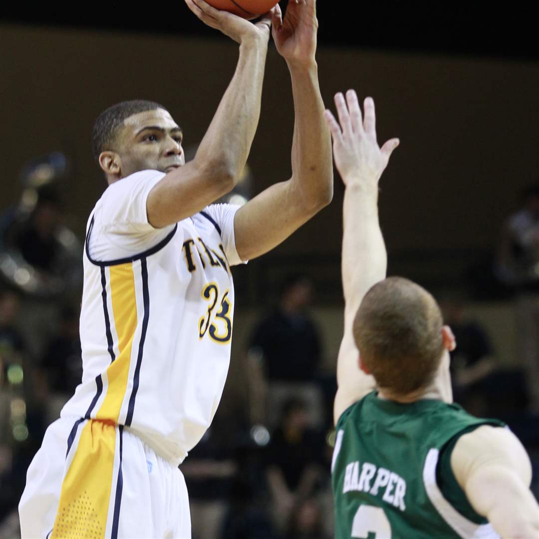Toledo-s-Curtis-Dennis-33-puts-up-a-three-point-shot-over-Eastern-Michigans-Austin-Harper