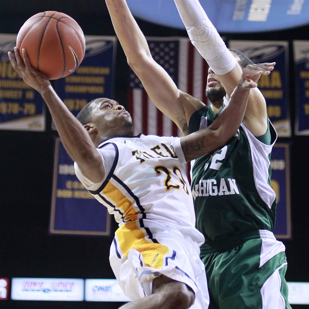 Toledos-Julius-Brown-20-is-fouled-by-Eastern-Michigans-Jamell-Harris