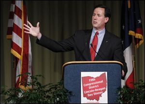 Former Pennsylvania Senator Rick Santorum told the 750 attendees that he would cut $5 trillion from the federal budget and work for a balanced budget amendment. But he also promised not to cut the defense budget, drawing a standing ovation.