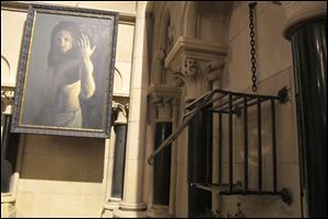 The iron cage that housed the heart of St. Laurence O'Toole sits broken and empty Sunday inside Christ Church Cathedral in Dublin. A modern portrait of Jesus Christ is in the background.