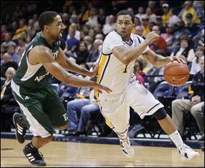 Toledo's Dominique Buckley drives against Eastern Michigan's Antonio Green during the second half of their men's basketball game at Savage Arena, Saturday.