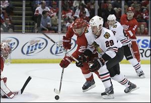 Detroit Red Wings defenseman Brad Stuart (23) redirects the puck from Chicago Blackhawks left wing Bryan Bickell (29) during the second period.