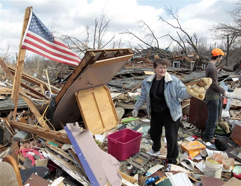 Melody-Zollman-finds-a-toy-bear-as-she-looks-through-the-rubble