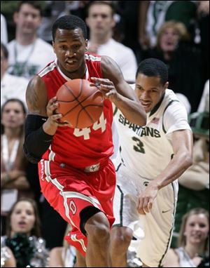 Ohio State's William Buford, left, gets a steal against Michigan State's Brandan Kearney (3) during the first half.