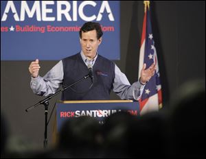 Rick Santorum speaks in Miamisburg, Ohio, near Dayton. In appearances Monday, he attacked Mitt Romney’s passage of a health law similar to President Obama’s.