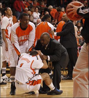 BG’s Jordon Crawford is consoled by Craig Sealey and Central Michigan assistant coach Terrance Chatman. Crawford missed a free throw with 2.7 seconds left.
