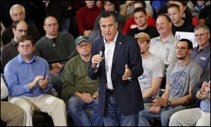 Mitt Romney addresses a rally in Youngstown. His theme for the day Monday was repeal of regulations enacted under President Obama, including health care.