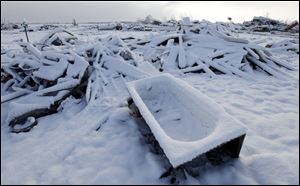Snow covers a demolished house in Marysville, Ind. The Midwest and South were struck by an estimated 30 tornadoes Friday. The storms killed 40 people, including three in southwest Ohio.
