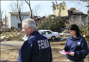 FEMA officials inspect tornado damage in Moscow, Ohio, which was mostly destroyed. Gov. John Kasich activated two disaster-relief programs Tuesday to aid Clermont County communities.