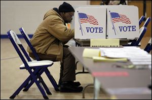 John Allen casts his vote at Sherman Elementary School in central Toledo. Toledoans voted Tuesday on renewal of the city income tax, as well as choosing candidates in the Democratic and Republican parties' primaries. Among local races was a GOP contest for a spot on the 6th District Court of Appeals.