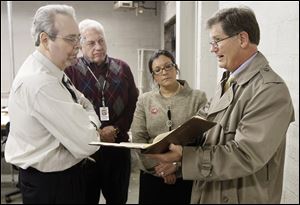 Keith Wilkowski, an attorney acting on Marcy Kaptur's behalf, confers with elections board members Tony DeGidio, Ron Rothenbuhler, and Keila Cosme after receiving reports that some voters in the 9th Congressional District received ballots listing 5th District candidates.