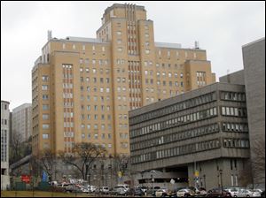 Police line O'Hara Street near the front  entrance to the Western Psychiatric Institute and Clinic, tan building, on the University of Pittsburgh campus, Thursday. There were reports of gunfire at the  psychiatric clinic injuring several people, and police were looking for a gunman.
