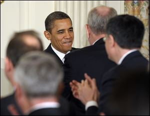 President Barack Obama greets guests as he arrives to speak before the National Governors Association in February at the White House in Washington.
