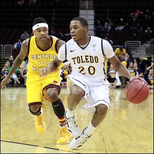 University of Toledo Rocket's Julius Brown controls the ball against the defense of Central Michigan's Derek Jackson in the first half of mens during the MAC tournament at Quicken Loans Arena in Cleveland.