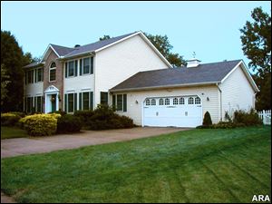 Garage doors as a fashion statement? Absolutely. Consider this home’s added curb appeal after a garage door update.