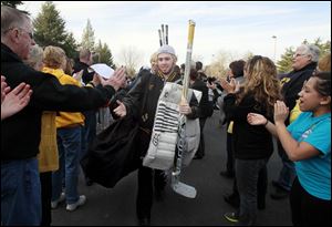 Austin Gryca leads Northview’s state championship hockey team through a tunnel of fans into the festivities.