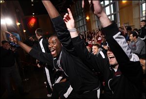 Harvard’s Kyle Casey, left, and Andrew Van Nest react to their draw to play Vanderbilt in the NCAA college basketball tournament during a selection show party on Sunday in Cambridge, Mass.