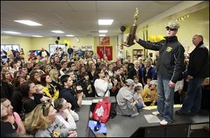Northview hockey coach Mike Jones shows off the state championship trophy for fans during the homecoming celebration at Tam O'Shanter. Former longtime coach Jim Cooper is at right.