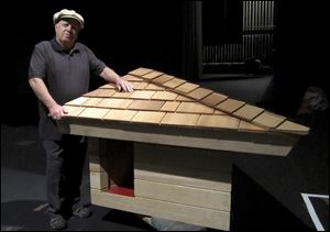 Jim Berger displays the doghouse built from a design that Frank Lloyd Wright created after receiving a handwritten request from Mr. Berger, who was 12 at the time, in 1956.