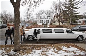 Ryan Kempenich searches for new listings inside the limo on a laptop with John Goettl, left, and Rich Goettl as they make their way to another property. The limo, which seats seven, has about $5,000 in electronics, including a computer, fax machine, and scanner, so that prospective buyers can move quickly once they've found a deal.