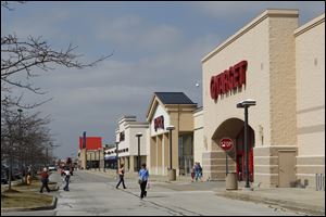 A shopping strip in Perrysburg has big-box stores including Target. Some development is occurring as the population shifts to certain areas, but experts say those days are largely over too.