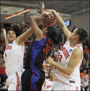 Ohio State defenders Kalpana Beach, left, and Ashley Adams, try to stop Florida's Jennifer George from shooting.