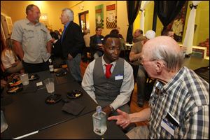 Chris McCail, left, and Paul Snepp, right, speak during Mantis and Moon Productions' cast party for The Society.