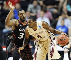 Cincinnati forward Yancy Gates (34) defends against Florida State forward Bernard James (5).