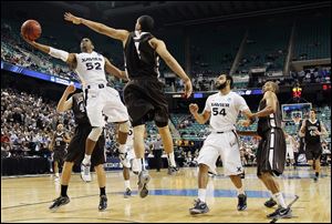 Xavier’s Tu Holloway (52) drives past Lehigh’s John Adams (4) during the second half of a third-round game in Greensboro, N.C. on Sunday.