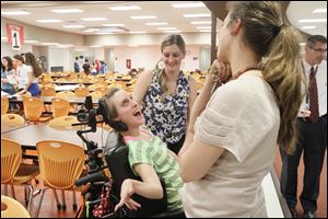 Holly Nartker, Valerie Taylor's teacher, left, and Carly Conover, right, a Southview High School advisor flank the sides of  Valerie Taylor, center, to share a moment while students and the family gather to prepare for the D4AC Project HAVEN.