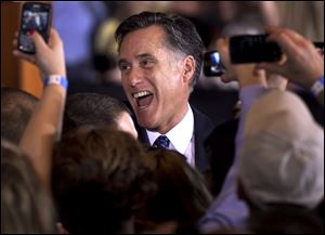 Republican presidential candidate, former Massachusetts Gov. Mitt Romney reacts while greeting supporters at a rally in Schaumburg, Ill., after the winning the Illinois Republican presidential primary, Tuesday.
