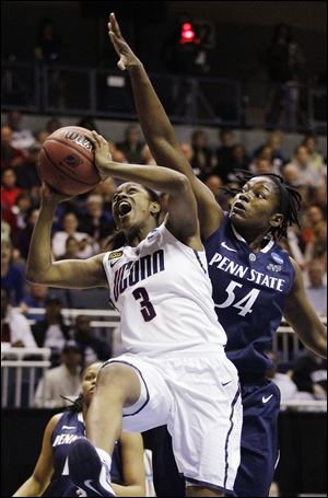 UConn’s Tiffany Hayes gets by Penn St.’s Nikki Greene during the first half of the Huskies’ win.